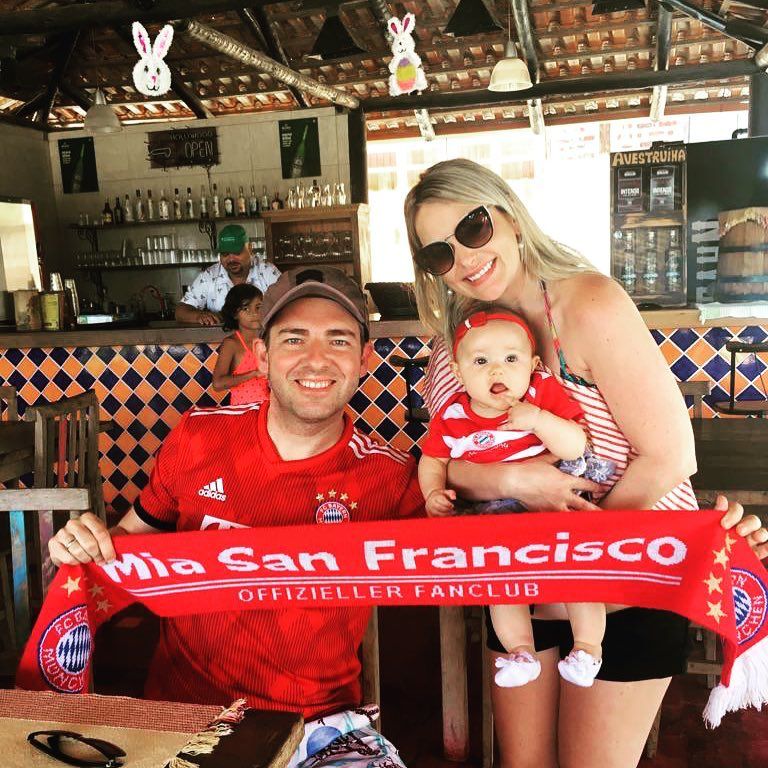 Bayern Munich fan family holding FC Bayern scarf at San Francisco beach