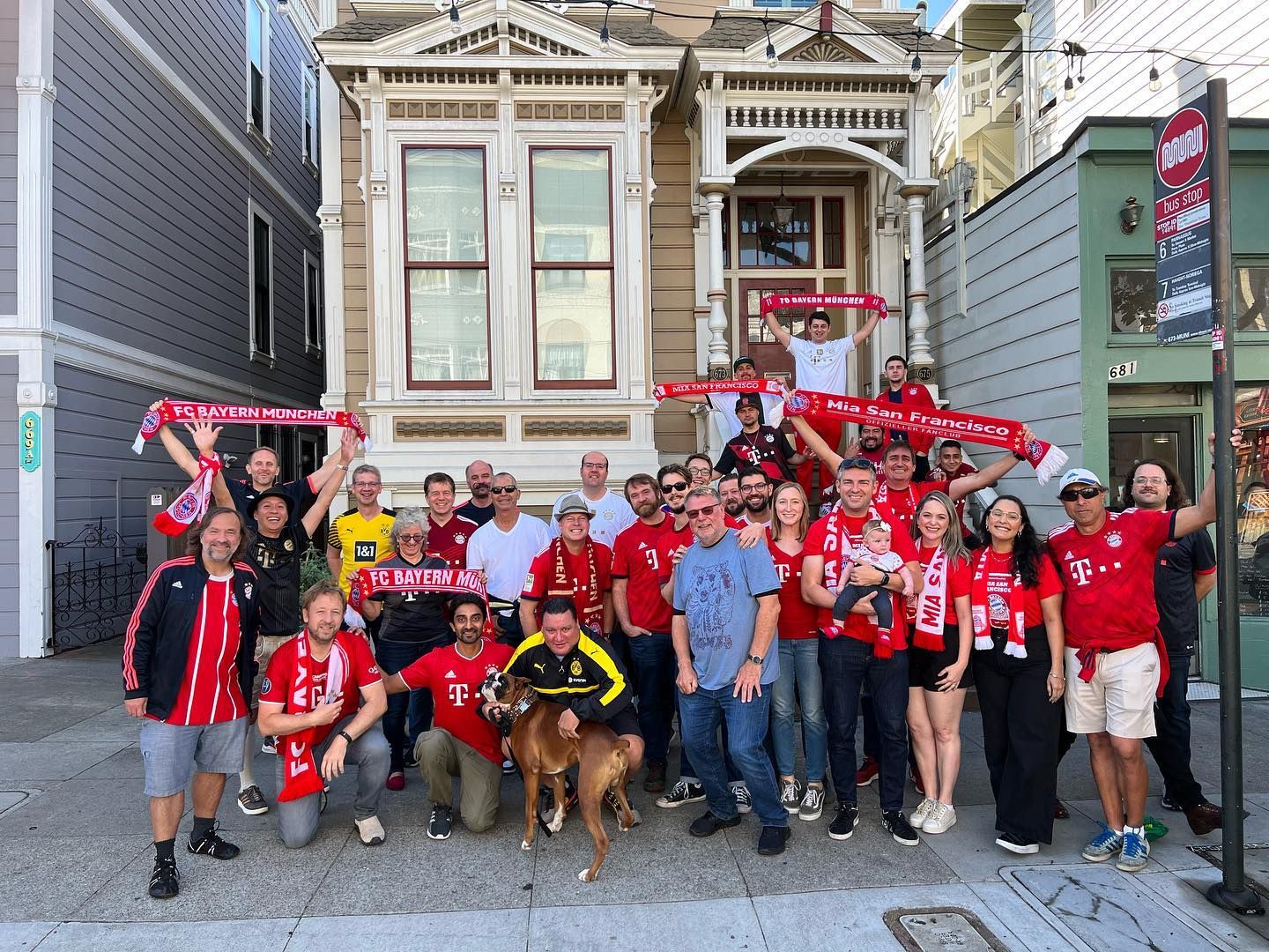 Bayern Munich fan club members posing in front of San Francisco Painted Ladies Victorian houses